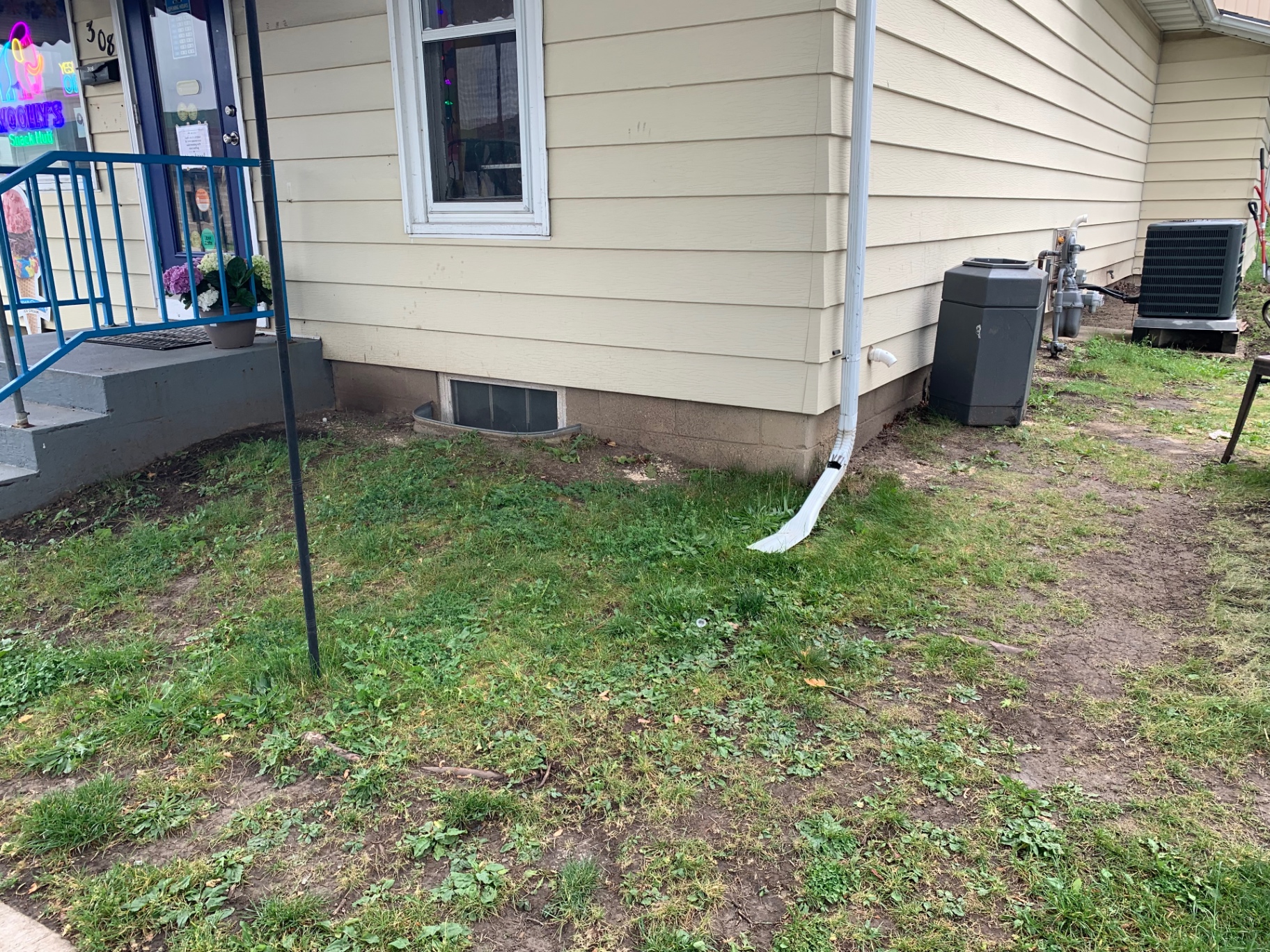 Storefront turf install — weedy strip to low-maintenance turf after