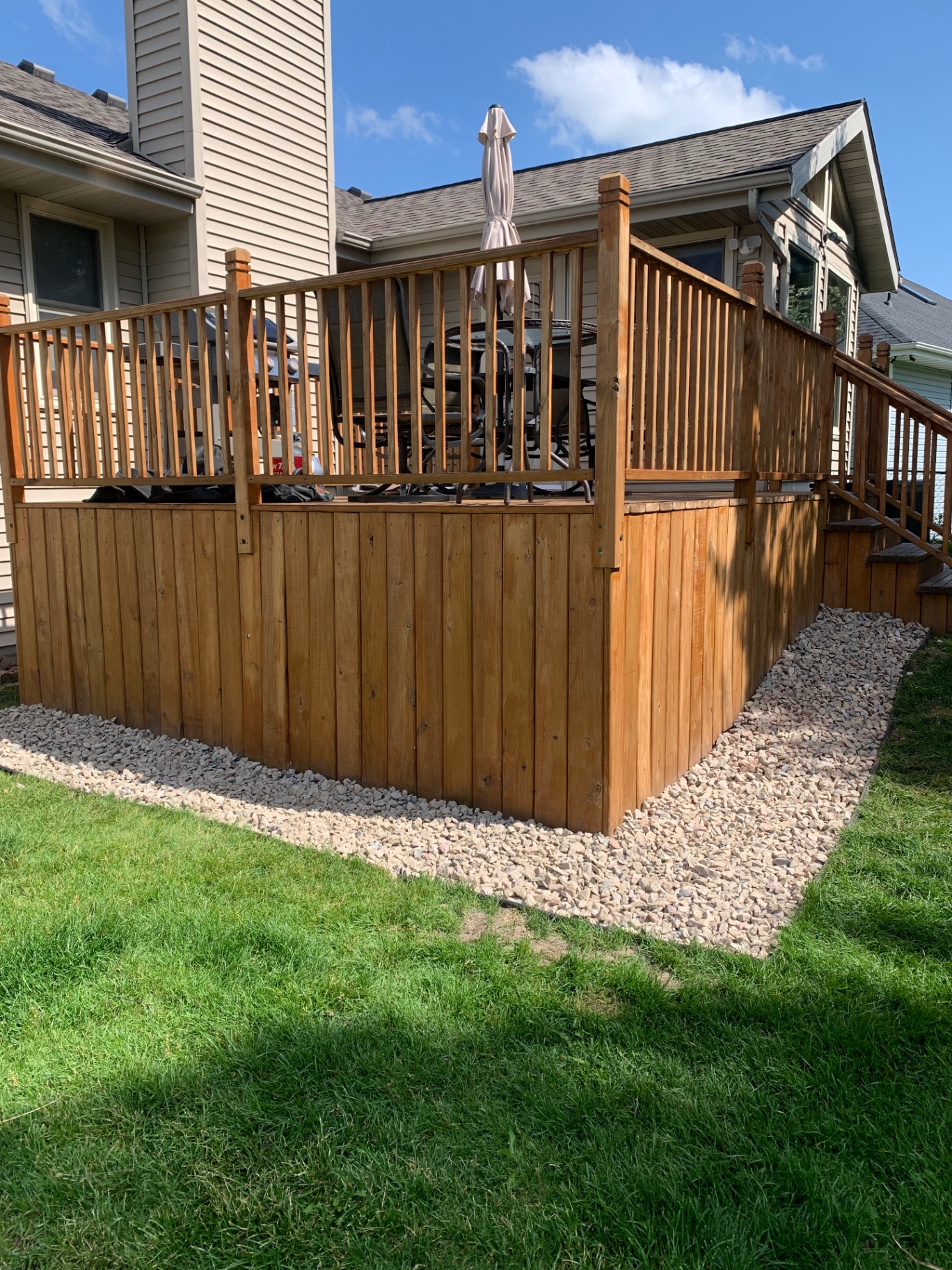 Deck skirt — grass to rock border before